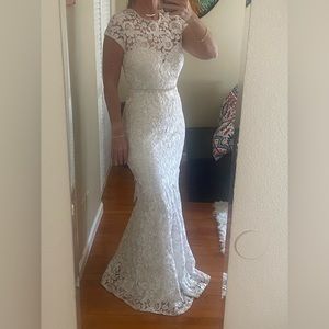 Long Ivory lace mermaid dress with cap sleeves. Back is open.